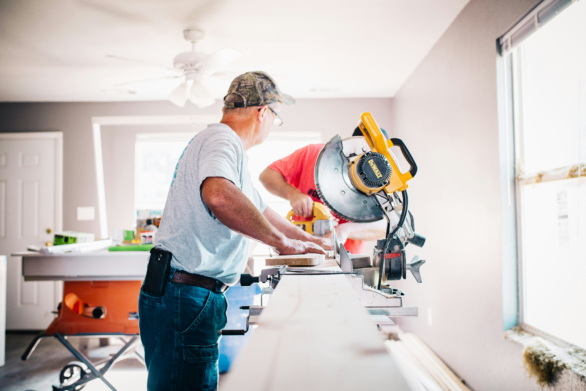 Friendly flooring installers reviewing samples with homeowners
